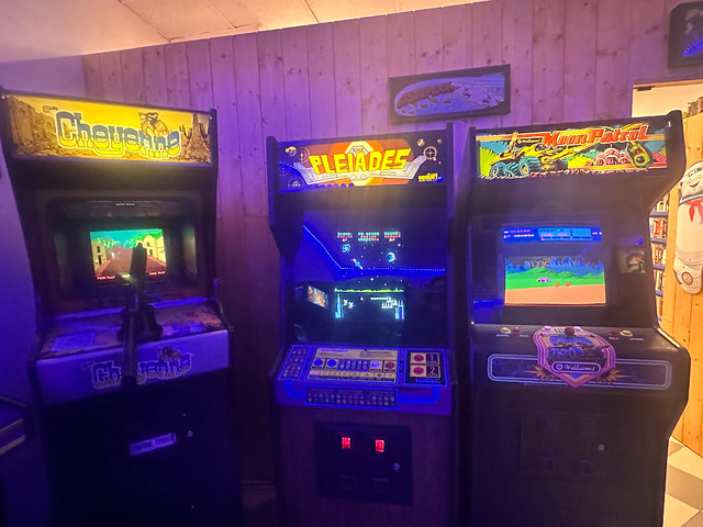 Visitors and players gathered around arcade and Tetris stations