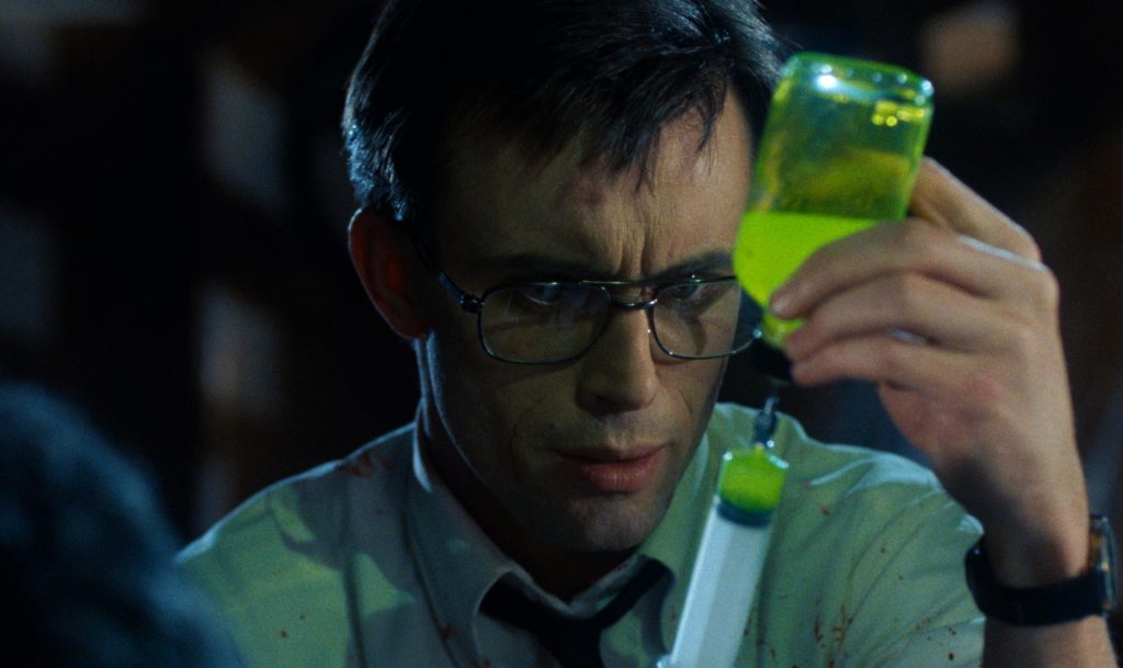 Re-Animator preparing a syringe in parody vaccination image
